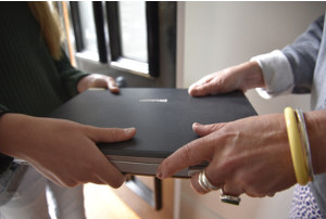 handing laptop to IT