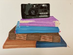 A pen drawing of a camera sitting on top a pile of four colourful notebooks.