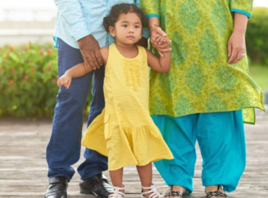 A South Asian father, mother and young daughter.