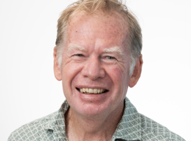 A man, Peter Waters, smiles into the camera.