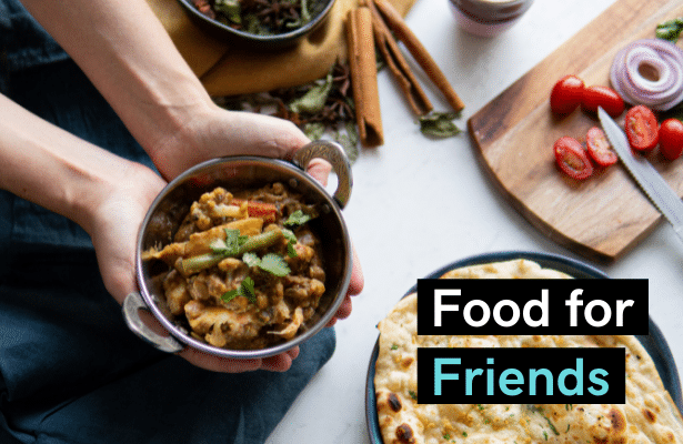 Two hands holding a bowl of vegetable curry, with the words 'Food for friends'