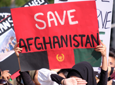 Someone holds a placard that reads 'Save Afghanistan' at a protest