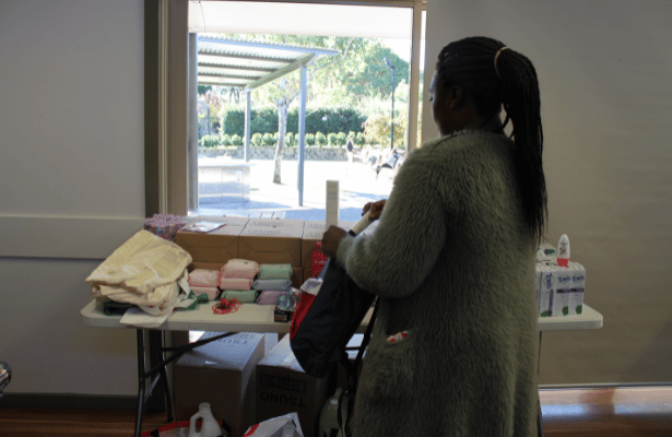 Sika picks up nappies and other items at the Asylum Seekers Centre Family Day.