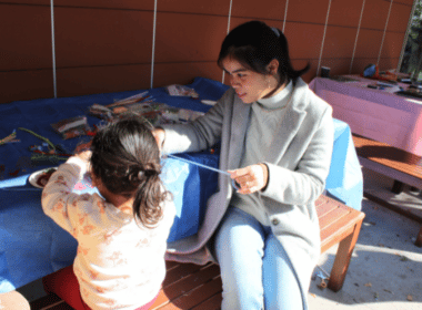ASC team member Gianne with a young girl whose family is seeking asylum in Australia.
