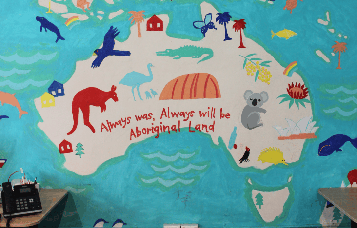 A painting at the ASC of a map of Australia with the words "Always was, always will be Aboriginal land."