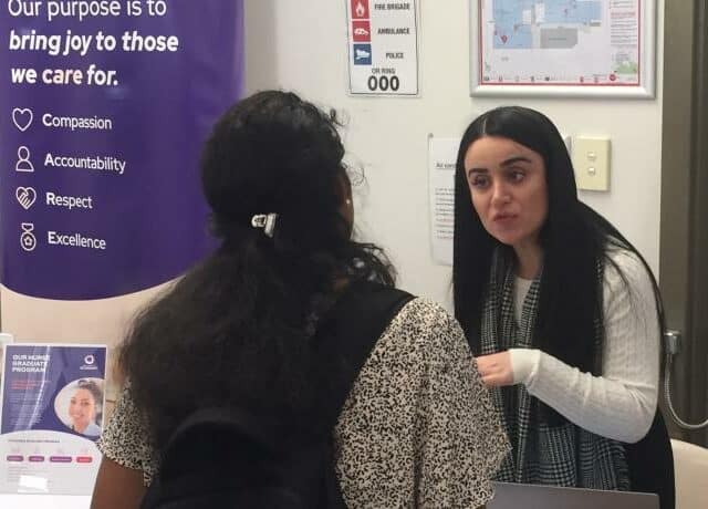 Two women talking at a Job Fair
