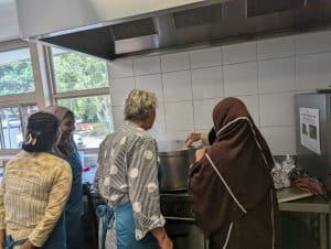 Women at the Knit and Nourish initiative cooking a meal