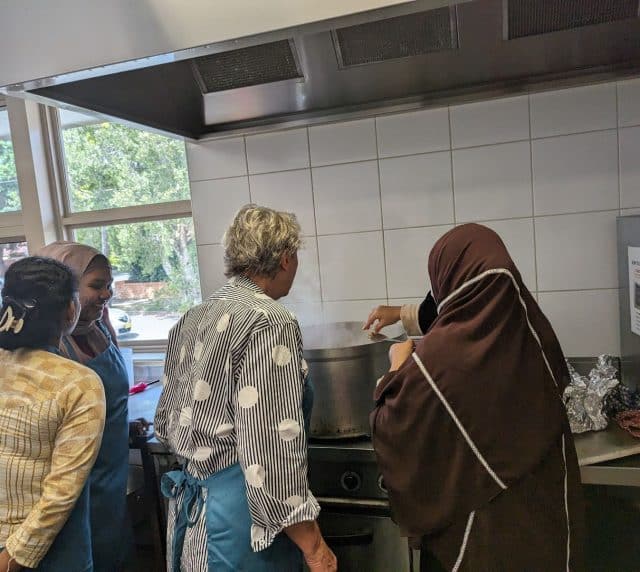 Women at the Knit and Nourish initiative cooking a meal