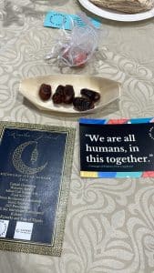 iftar table setting with dates and a flyer