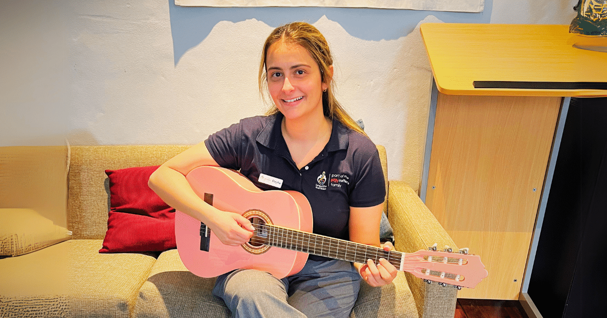 Eleisha holding a guitar